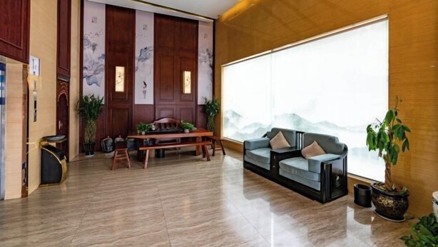 A spacious living area with a wooden floor, a sofa set, a dining table, and a large window with a view. - Linhai H Chain Lihao Star Hotel (Linhai)