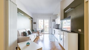 A modern apartment with a living room, dining area, and kitchen. - Chiaia Mon Amour Elegant Flat by Napoliapartments (Naples)