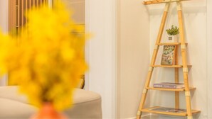 A wooden ladder shelf with a small plant and framed picture, placed against a white wall. - Sokcho Seohyeon Ine Pension (Sokcho)