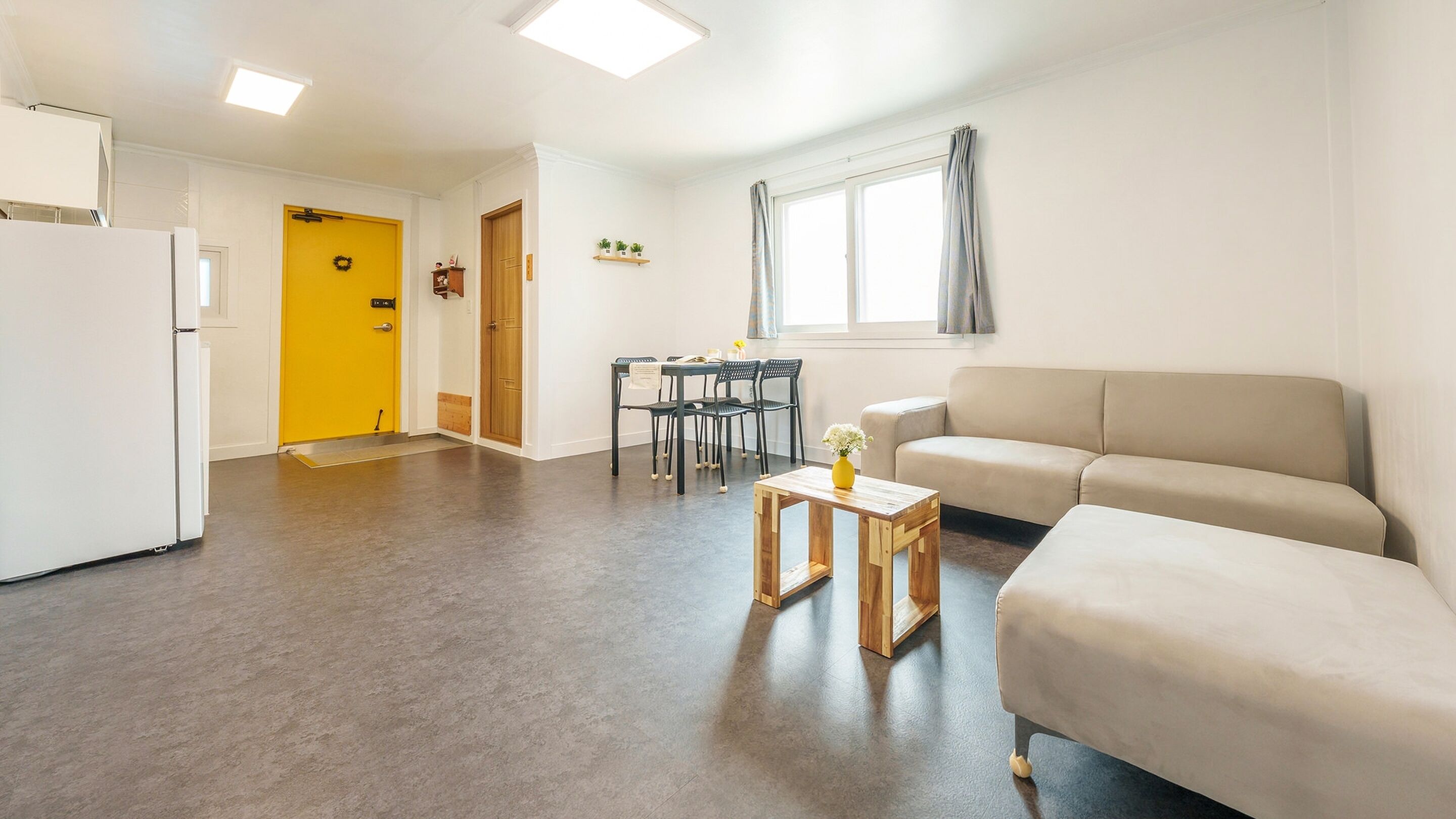 A compact living space with a kitchenette, a dining area, and a seating area.