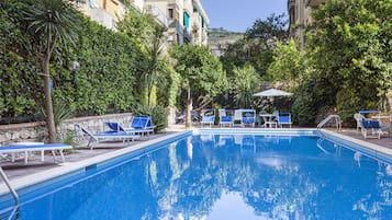 Seasonal outdoor pool, open 10:00 AM to 6:00 PM, pool loungers