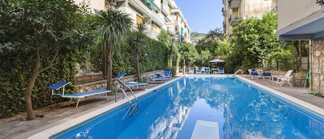 Seasonal outdoor pool, open 10:00 AM to 6:00 PM, pool loungers