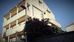 A multi-story building with balconies and a street lamp. - Apartment 11 Sleeps 4 Guests (Split)