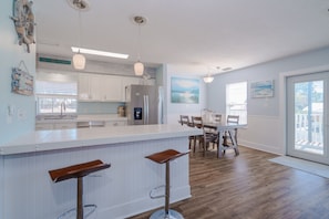 Enjoy meals at the central island with bar stools or gather around the dining table and chairs.