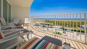 A balcony with a view of a pool and beach. - Caribe The Resort D614 3 Bedroom Condo (Orange Beach)