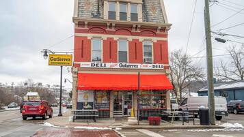 A two-story building with a red awning and a sign for Gutierrez deli.