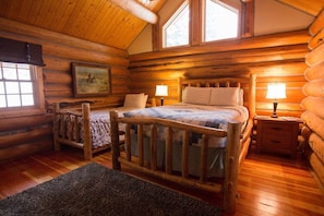 Relax in this charming room with a large bed, bedside tables, and a framed picture above.