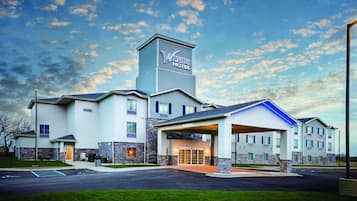 Experience the grand entrance of The Winds Hotel, featuring a prominent tower and covered entrance with convenient parking and handicapped accessibility.