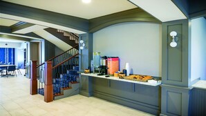 A modern interior with a staircase, a coffee station, and a dining area. - Winds Hotel At Crosswinds Casino (Park City)