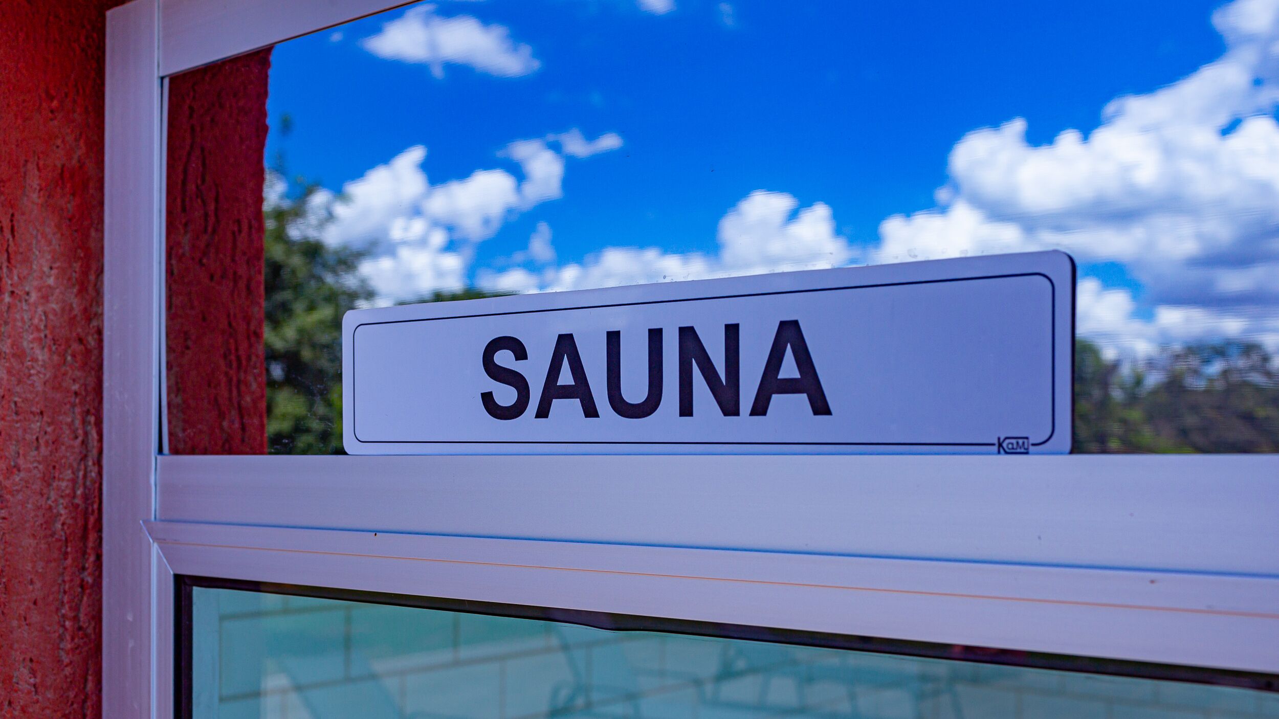 A sign with the word "SAUNA" on a window.