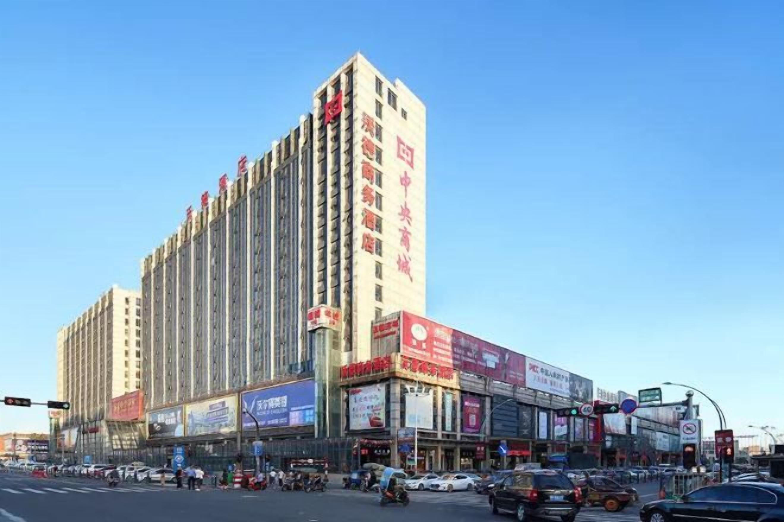 A tall hotel with multiple floors and a prominent sign on the facade.