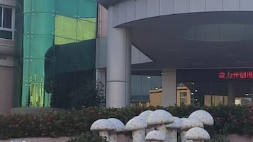 A building with a modern architectural design, featuring a curved facade and a prominent cylindrical structure.