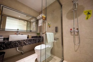 A modern bathroom with a glass shower enclosure, a white toilet, a marble countertop, and a mirror above the sink. - Lingyun Zhuangzhi Lingyun International Hotel (Lingyun)