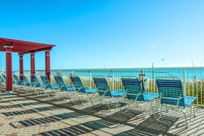 Relax on the seaside promenade with comfortable sun loungers and a scenic view of the beach.