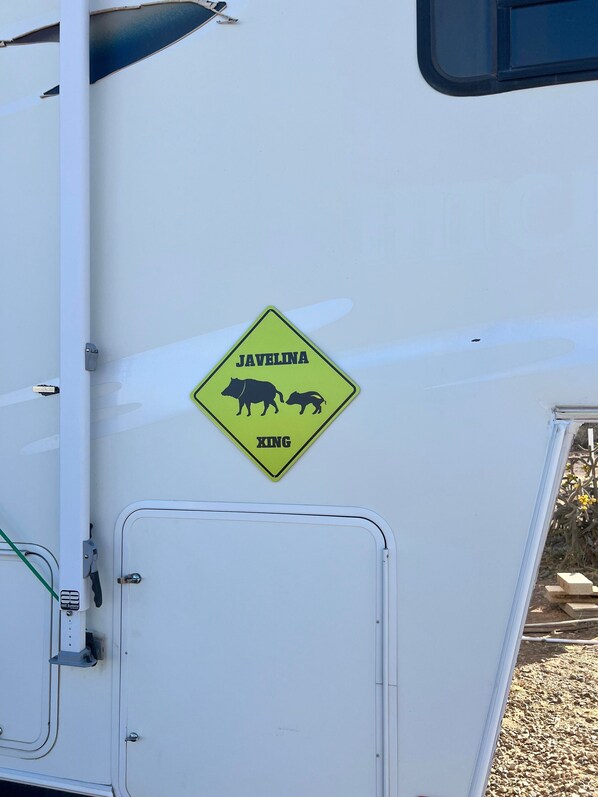 A vehicle with a yellow warning sign indicating the presence of wild boars.