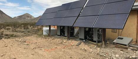 Une installation de panneaux solaires avec un bâtiment en arrière-plan.