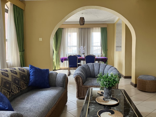 Family Studio Suite | Living area | 30-inch flat-screen TV with cable channels, TV