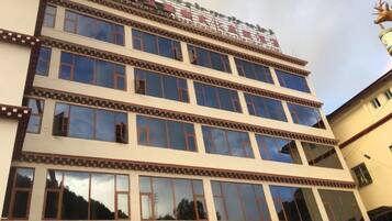 A multi-story building with a traditional architectural style, featuring a series of windows and decorative elements.