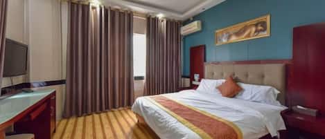 A hotel room with a bed, a desk, a TV, and a painting on the wall.