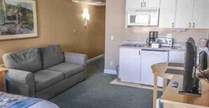 Enjoy a compact room with a kitchenette, sofa, and TV, perfect for a convenient stay.