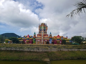 A colorful castle-like building with multiple towers and a central spire.