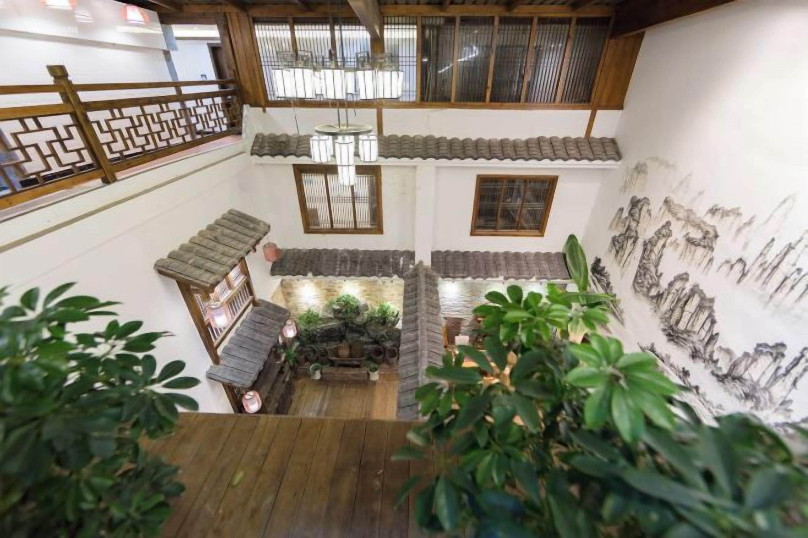 A traditional Japanese interior with tatami flooring, shoji screens, and a hanging lantern.