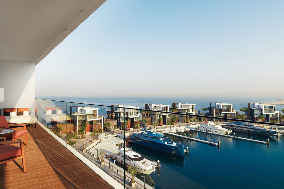 A modern hotel balcony with a view of the sea and marina.