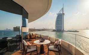 A balcony with a view of the city skyline, including a distinctive sail-shaped building. - Jumeirah Residences Marsa Al Arab (Dubai)