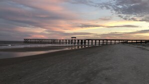 A beach with a pier extending into the water. - Walk to beach. Perfect for families & couples. Pool & tennis onsite. (Fernandina Beach)