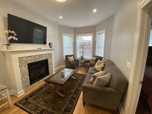 Apartment - 3rd Floor | Living area | 55-inch flat-screen TV with digital channels, TV, fireplace - Wrigleyville Inn (Chicago)