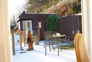 Enjoy dining al fresco in this charming outdoor space with a table and chairs.