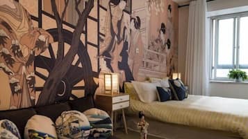 Ein Schlafzimmer mit einem großen Bett, einer Couch und einem Nachttisch mit Lampe.