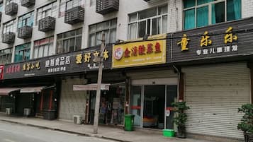 A street view of a row of closed shops with visible signage.