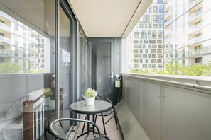 Enjoy dining or relaxing on this spacious balcony with a round table and two chairs.
