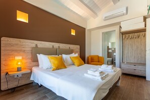 A hotel room with a large bed, a wooden headboard, a nightstand with a lamp, a wardrobe, and a mirror. - Villa Ada by MMega Villas  (Lapedona)