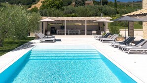 A swimming pool with lounge chairs and a covered seating area. - Villa Ada by MMega Villas  (Lapedona)