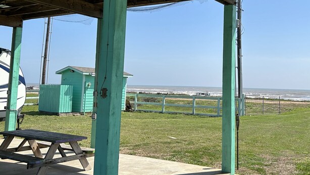 A beachside pavilion with a picnic table, a small shed, and a view of the ocean. - This property has it all! Beach and Intercoastal frontage. (Bay City)