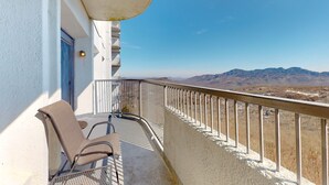 A balcony with a view of mountains, a chair, and a railing. - Mountain-top condo with amazing views, pool, hot tub, gym, & W/D (Sugar Mountain)