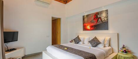 A modern bedroom with a large bed, a flat-screen TV, a painting, and a small side table.