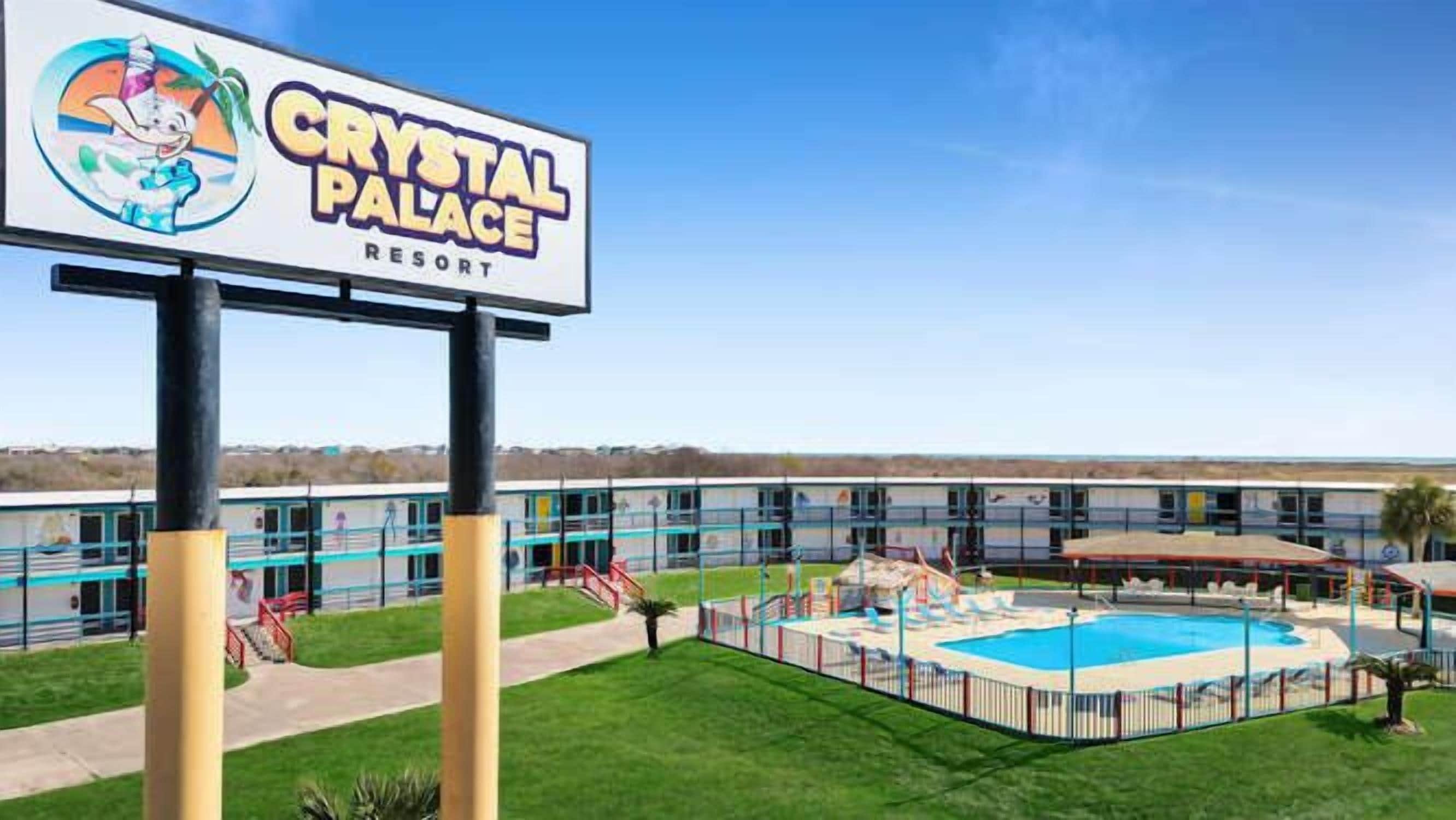 A hotel named Crystal Palace Resort with a swimming pool and a covered area.