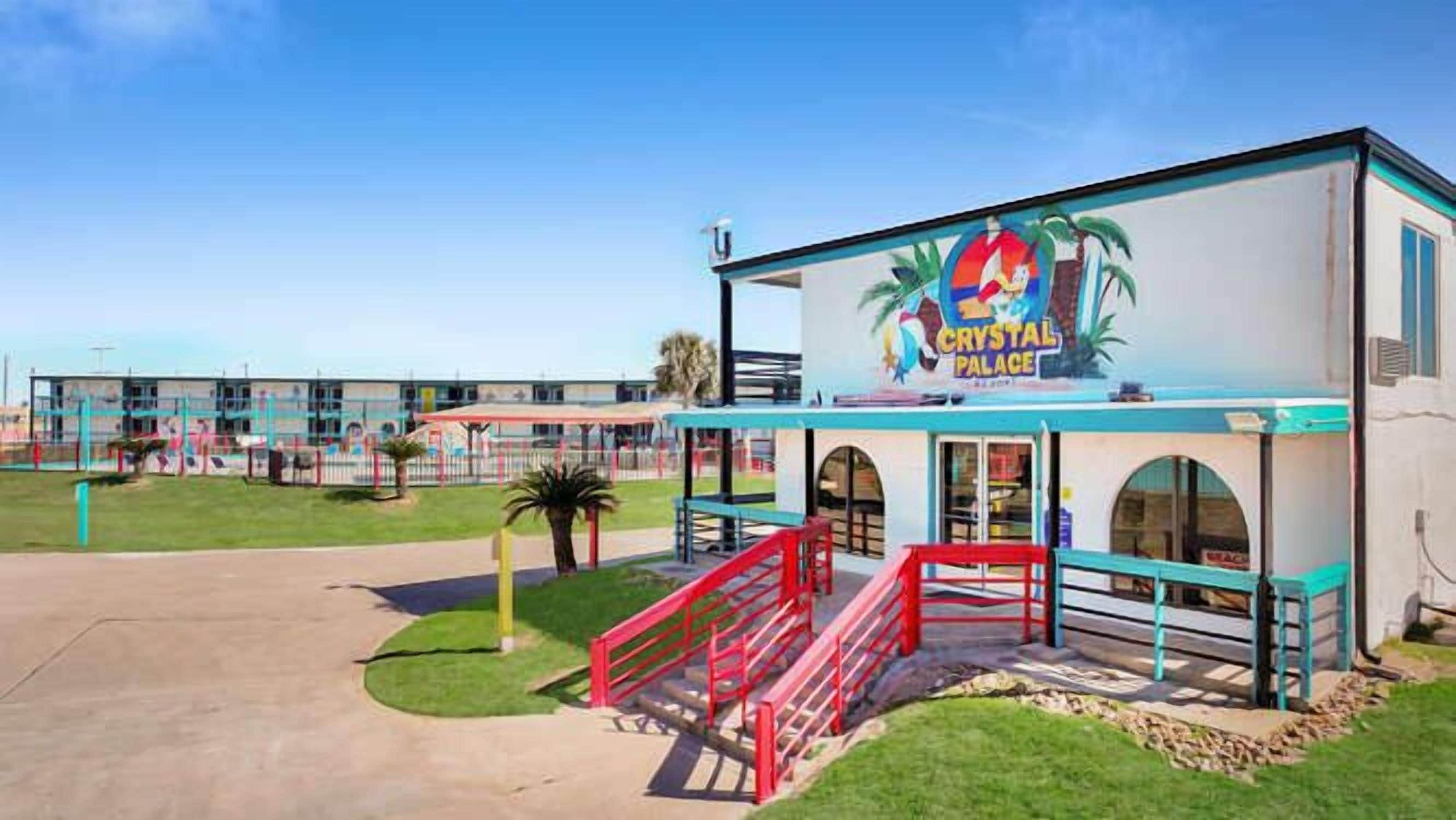 A building with a sign reading 'Crystal Palace' and a red staircase leading to the entrance.