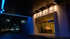 The exterior of the Sabai City Hotel with a modern facade, illuminated signage, and a glass entrance. - Sabae City Hotel (Sabae)