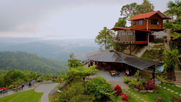 A restaurant with outdoor seating overlooking a mountainous landscape. - Kokol Haven Resort (Kota Kinabalu)