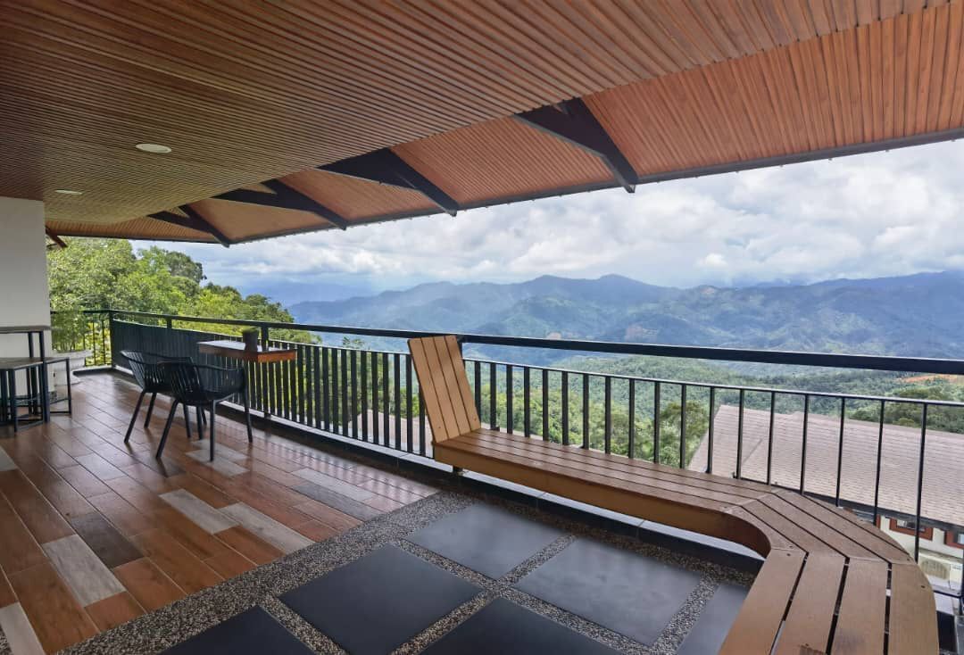 A wooden deck with a view of mountains.