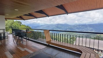 A wooden deck with a view of mountains.