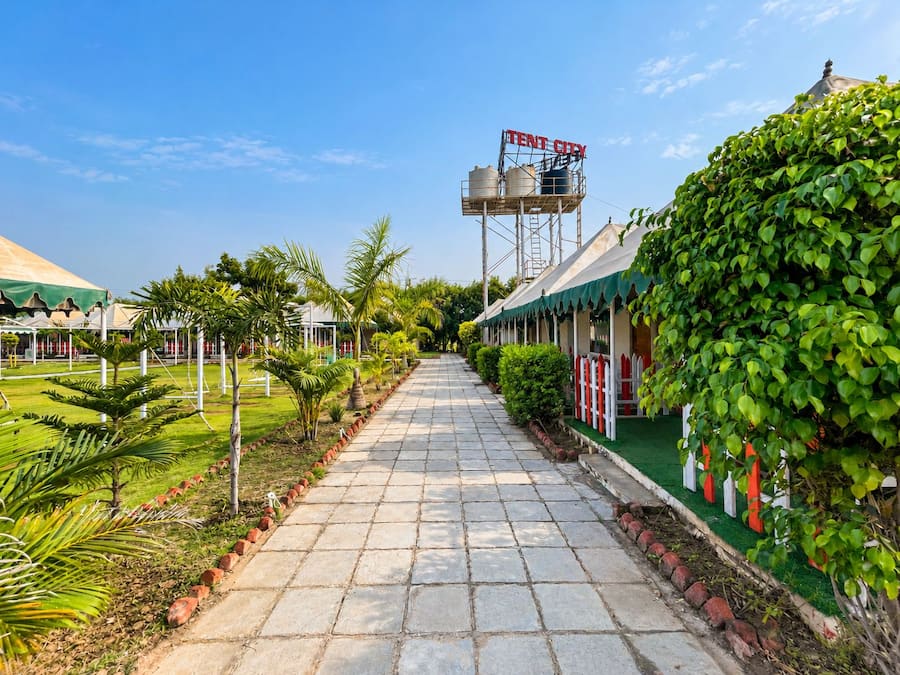 A pathway leading to a row of buildings with a water tower labeled 'TENT CITY' in the background.