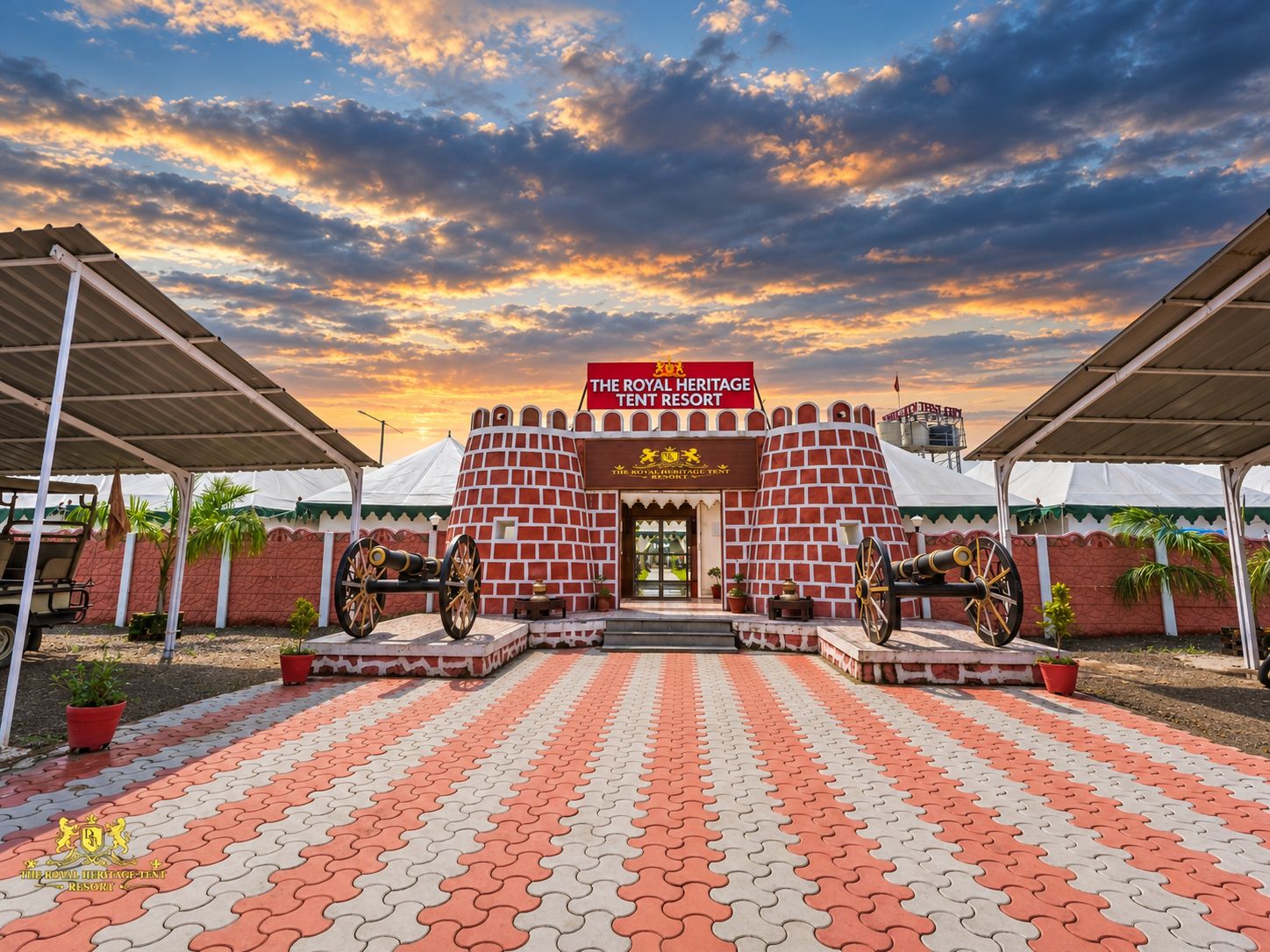 The Royal Heritage Tent Resort entrance with a brick facade, two cannons, and a patterned walkway.