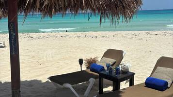 On the beach, sun loungers, beach towels