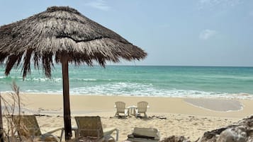 On the beach, sun loungers, beach towels