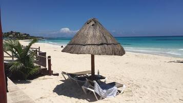 On the beach, sun loungers, beach towels